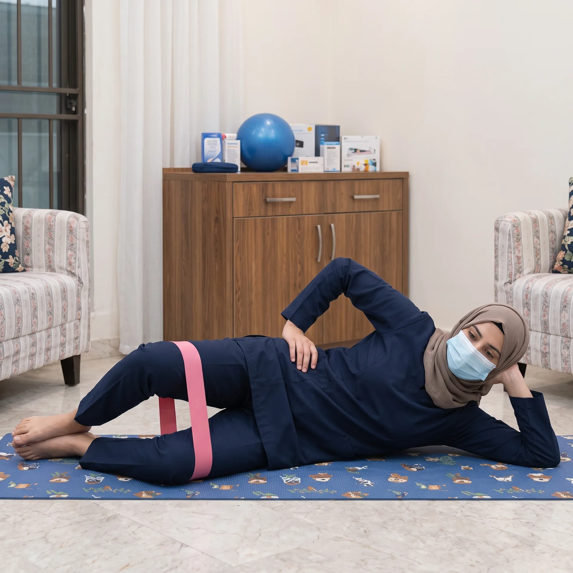 Woman using a resistance band around her knees during a clamshell exercise for knee pain