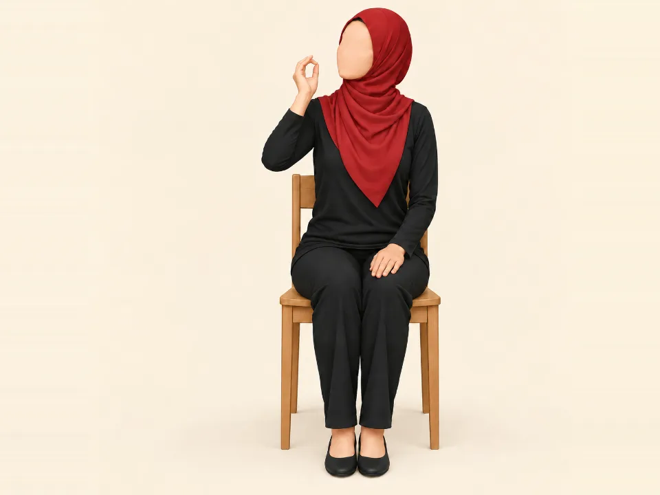 Woman in a red hijab with her arm out to the side making a loose ring with her thumb and finger, bringing her hand toward her face.