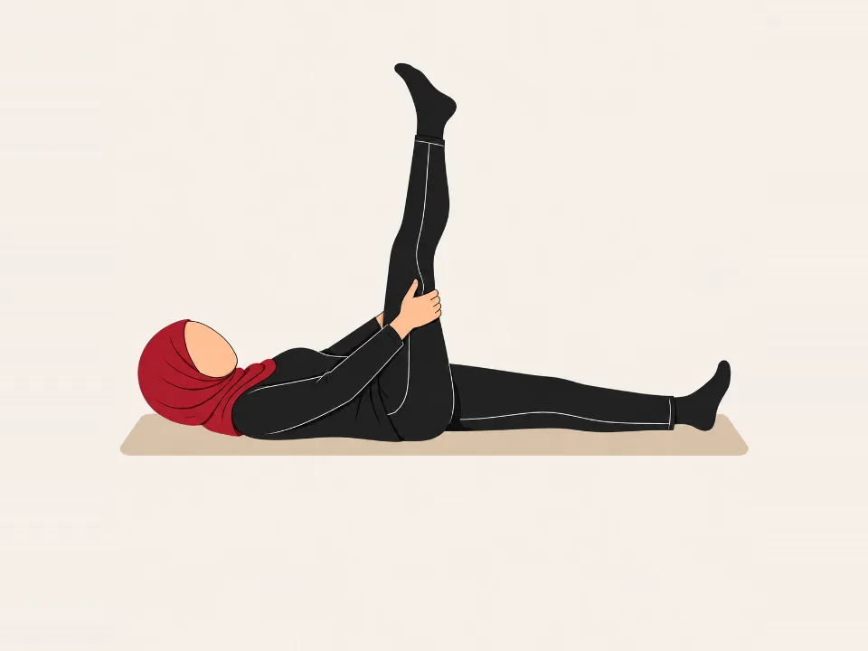 Woman in a red hijab lying on her back holding behind one thigh, straightening the knee.