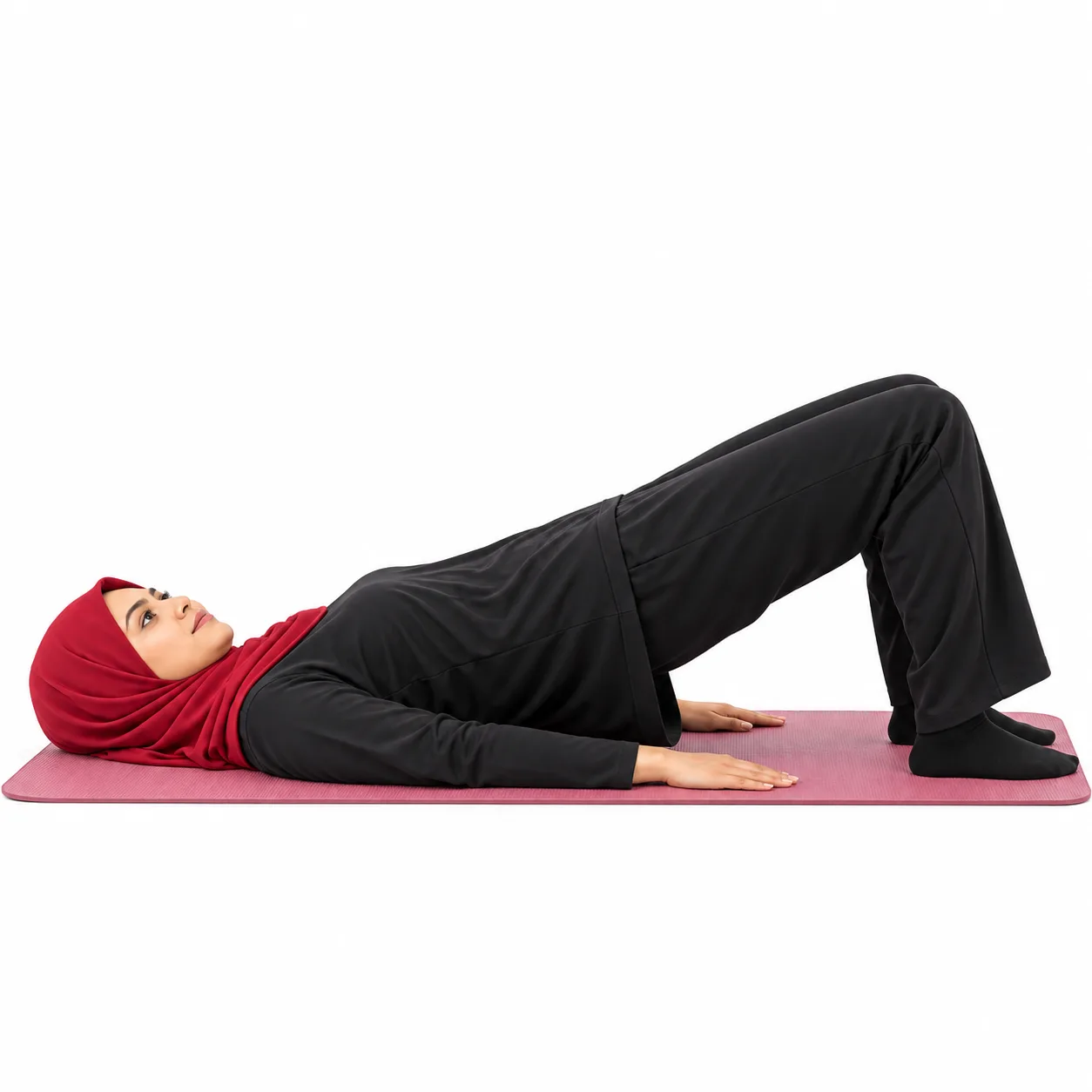 Illustrative image, not a real patient. A woman lying on a mat in a gentle low bridge with her hips lifted a little and her hands by her sides.