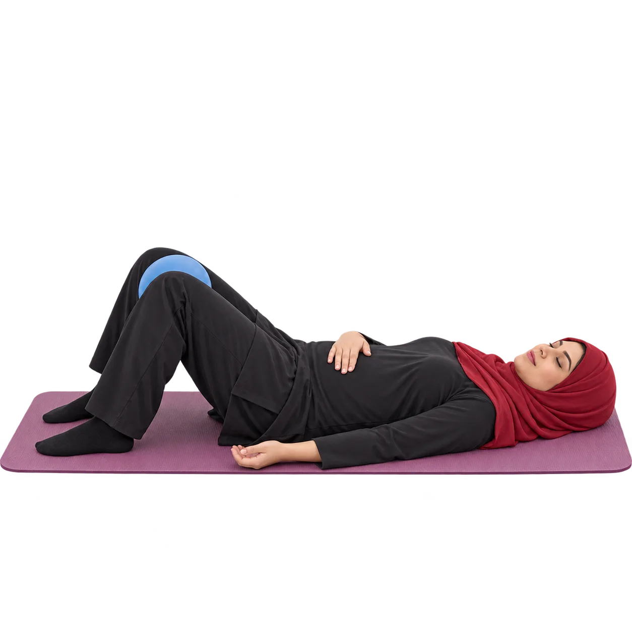 Illustrative image, not a real patient. A woman lying on her back on a mat with a soft ball between her knees and a hand on her lower abdomen, practising a pelvic floor exercise.