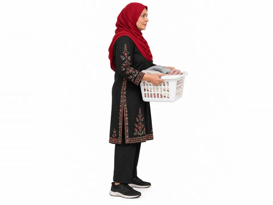 Illustrative image, not a real patient. A woman in a red hijab stands upright holding a laundry basket close to her body at waist height.