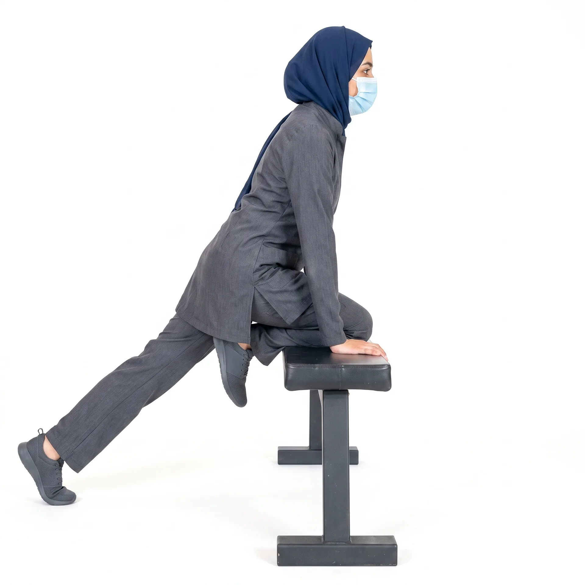 Woman performing a single-leg balance exercise on a bench for foot and ankle tendon conditions