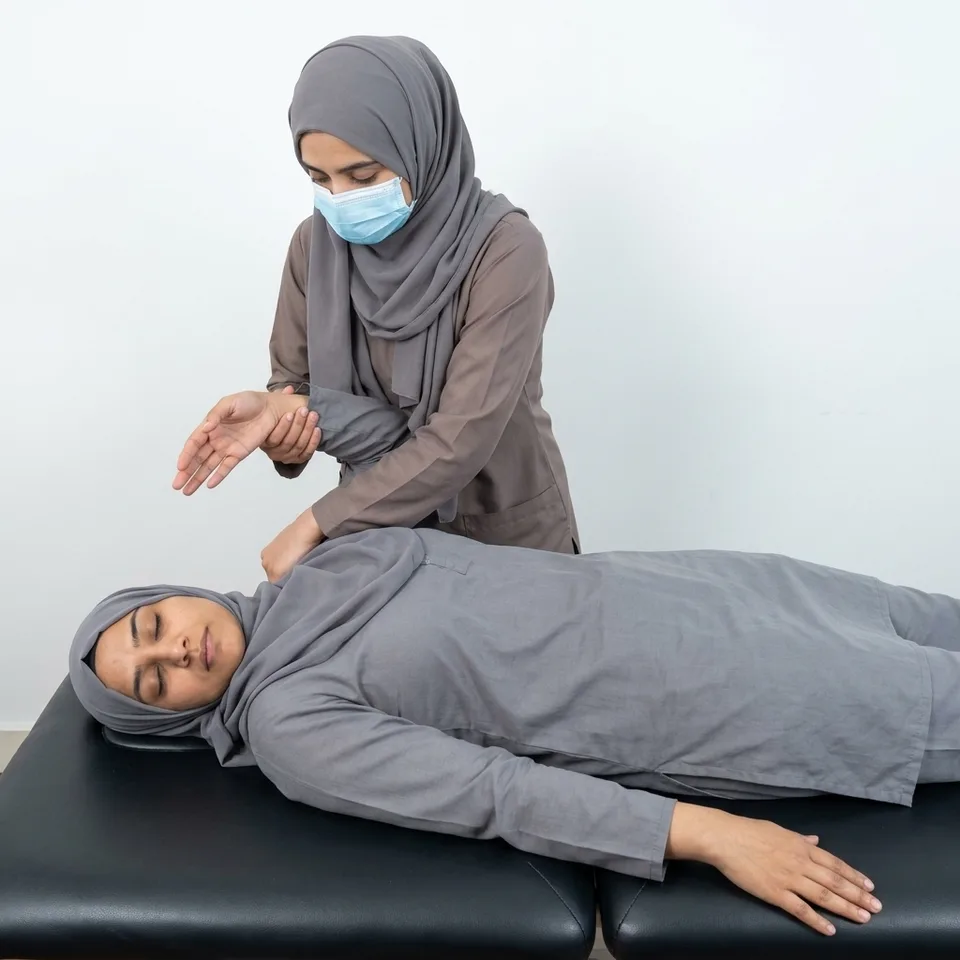 Physiotherapist assessing a patient's arm for nerve-related tingling and weakness