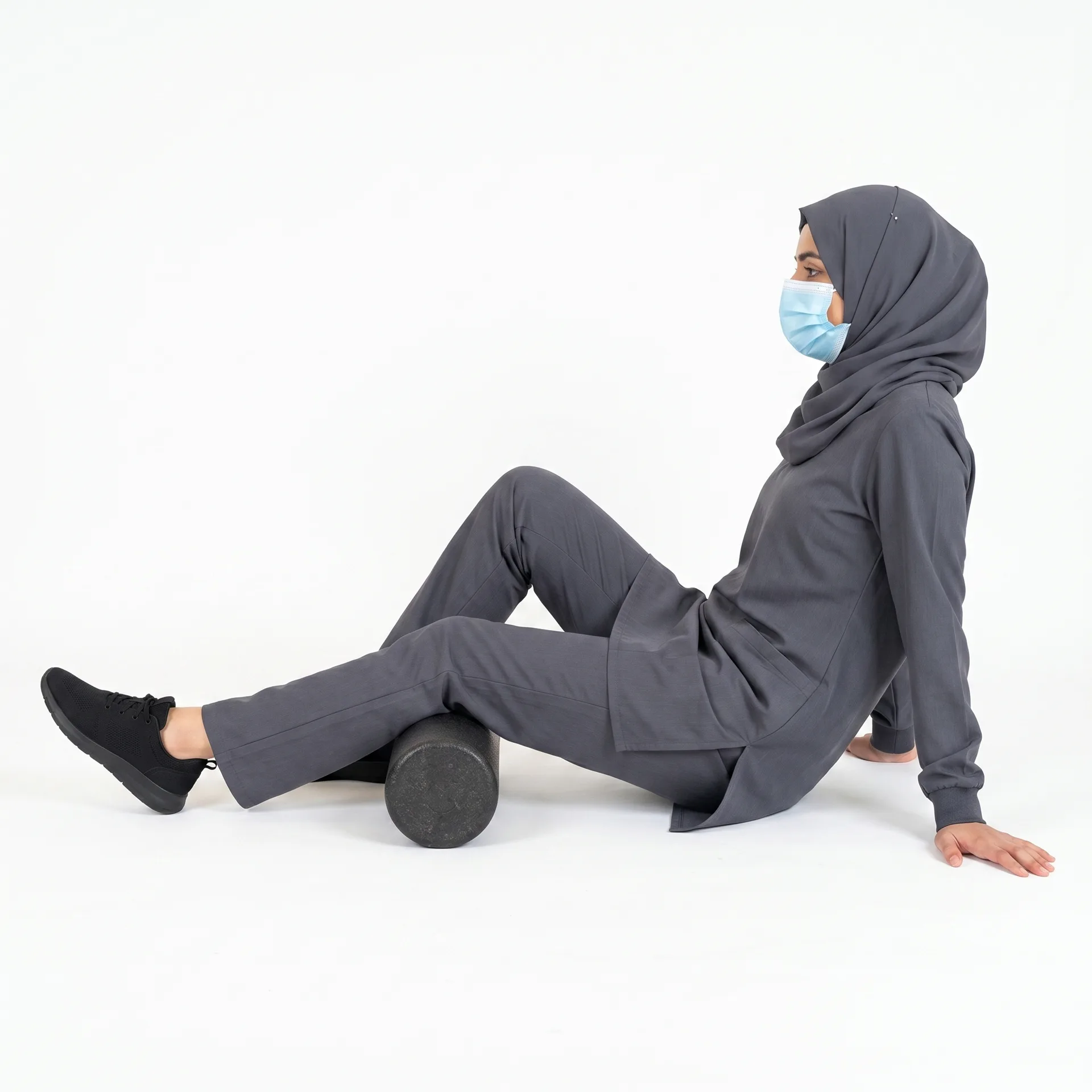 Woman using a foam roller on her leg as part of knee ligament injury rehabilitation
