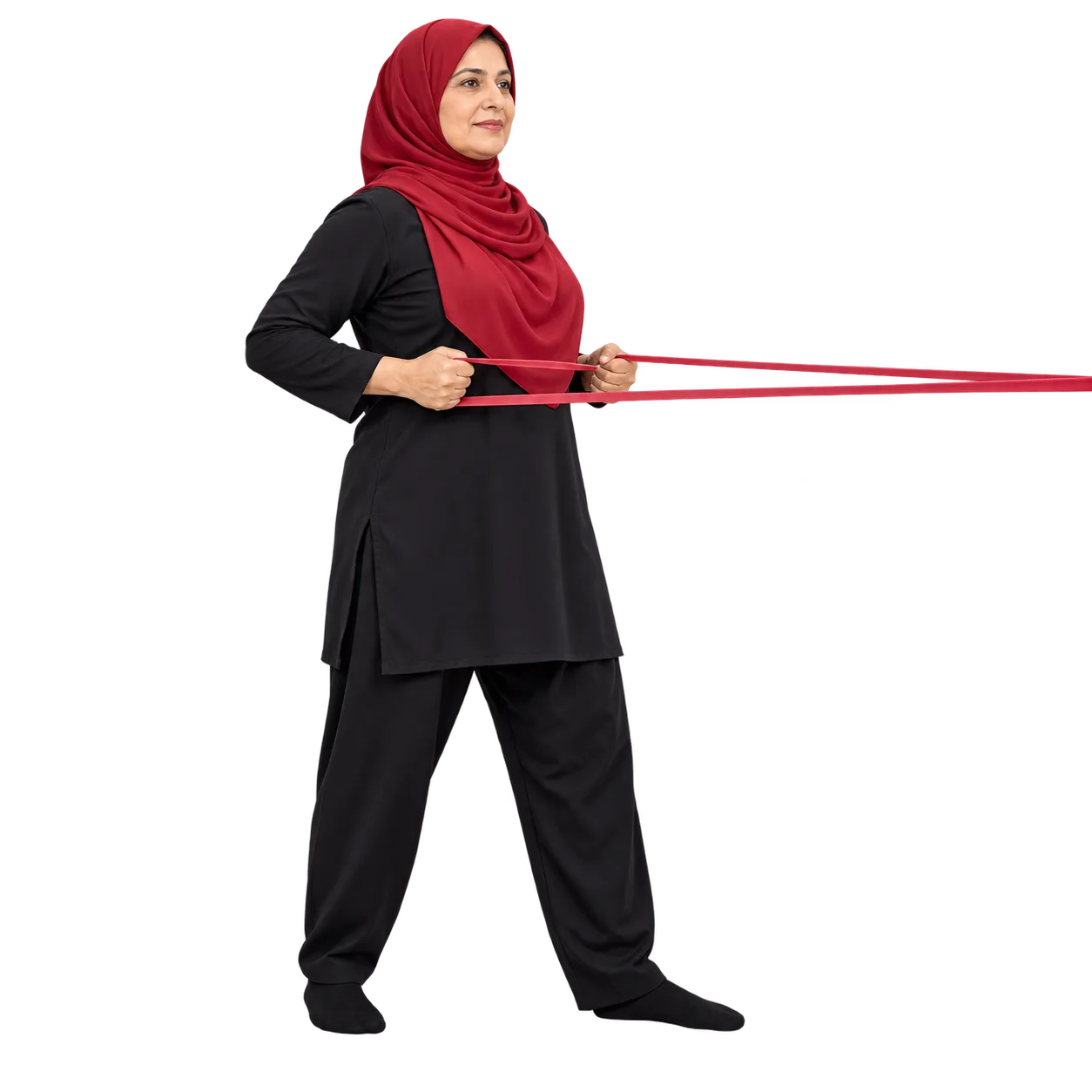 Illustrative image, not a real patient. A woman about fifty standing and pulling a resistance band back in a row, strengthening exercise used through the menopause transition.