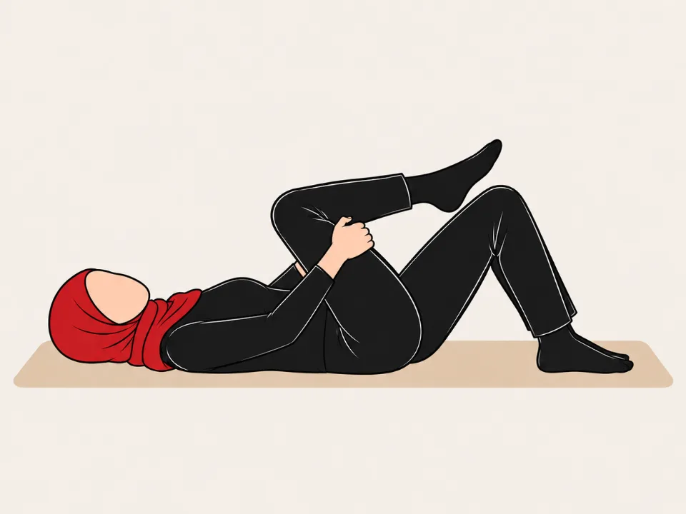 Woman in a red hijab lying on her back, drawing one knee towards her chest.